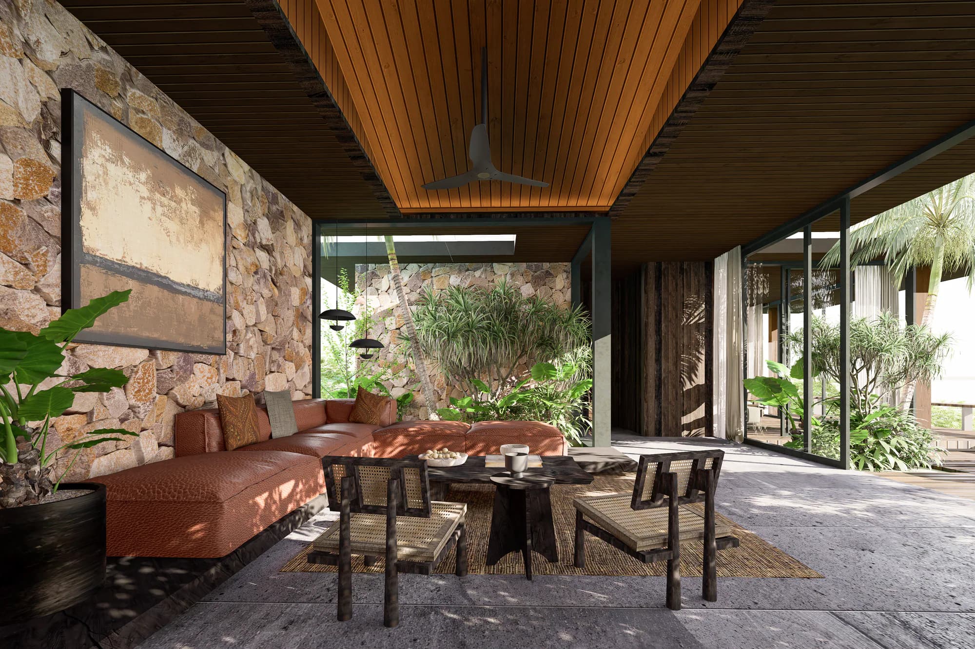 Woonkamer van de drie-slaapkamer villa van AURAH met natuurstenen wand en tropische binnentuin.