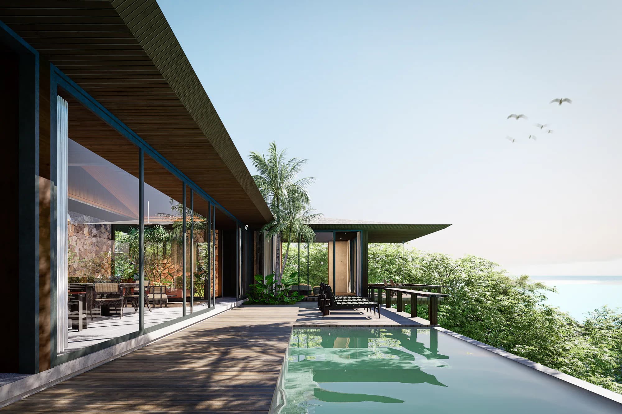 Zwembadterras van de twee-slaapkamer villa van AURAH met glazen gevel en uitzicht op de oceaan.