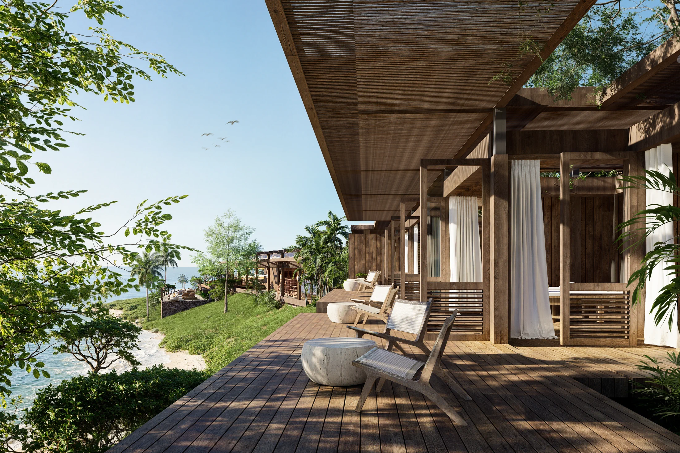 Terras van de AURAH spa met ligbedden, houten paviljoens en uitzicht over de oceaan bij Lombok.