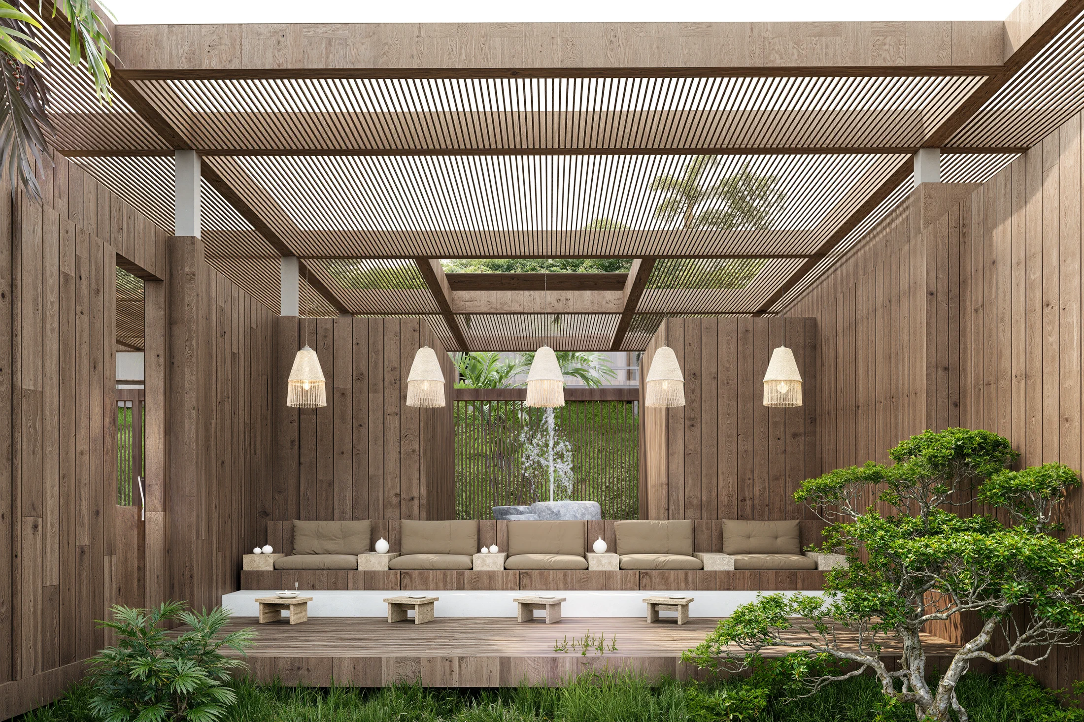 Waterbinnenhof van de AURAH spa met houten terras, fontein en een rustige natuurlijke inrichting.